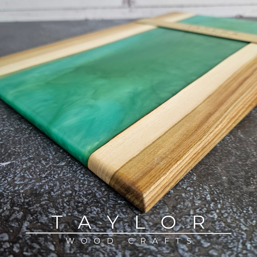 Handmade epoxy resin river charcuterie boards combining natural hardwood with striking resin designs, crafted in Northern Ireland for serving food and entertaining guests.