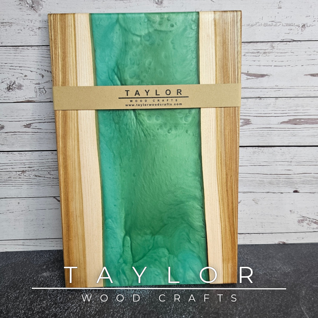 Handmade epoxy resin river charcuterie boards combining natural hardwood with striking resin designs, crafted in Northern Ireland for serving food and entertaining guests.