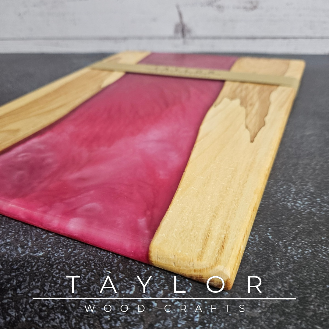 Handmade epoxy resin river charcuterie boards combining natural hardwood with striking resin designs, crafted in Northern Ireland for serving food and entertaining guests.