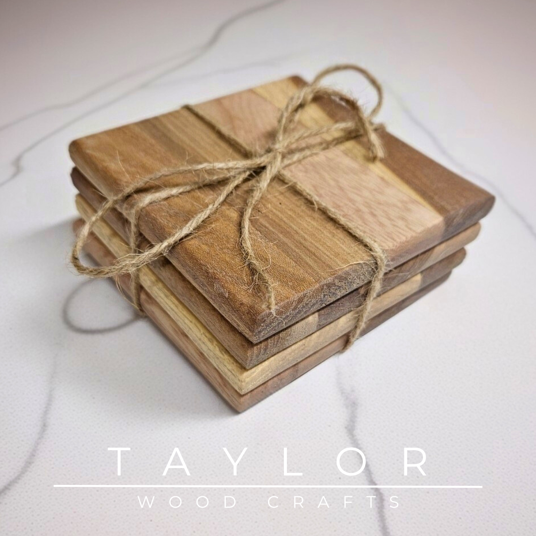 Wooden coasters and cutting boards with 'Taylor Wood Crafts' branding on a marble surface.