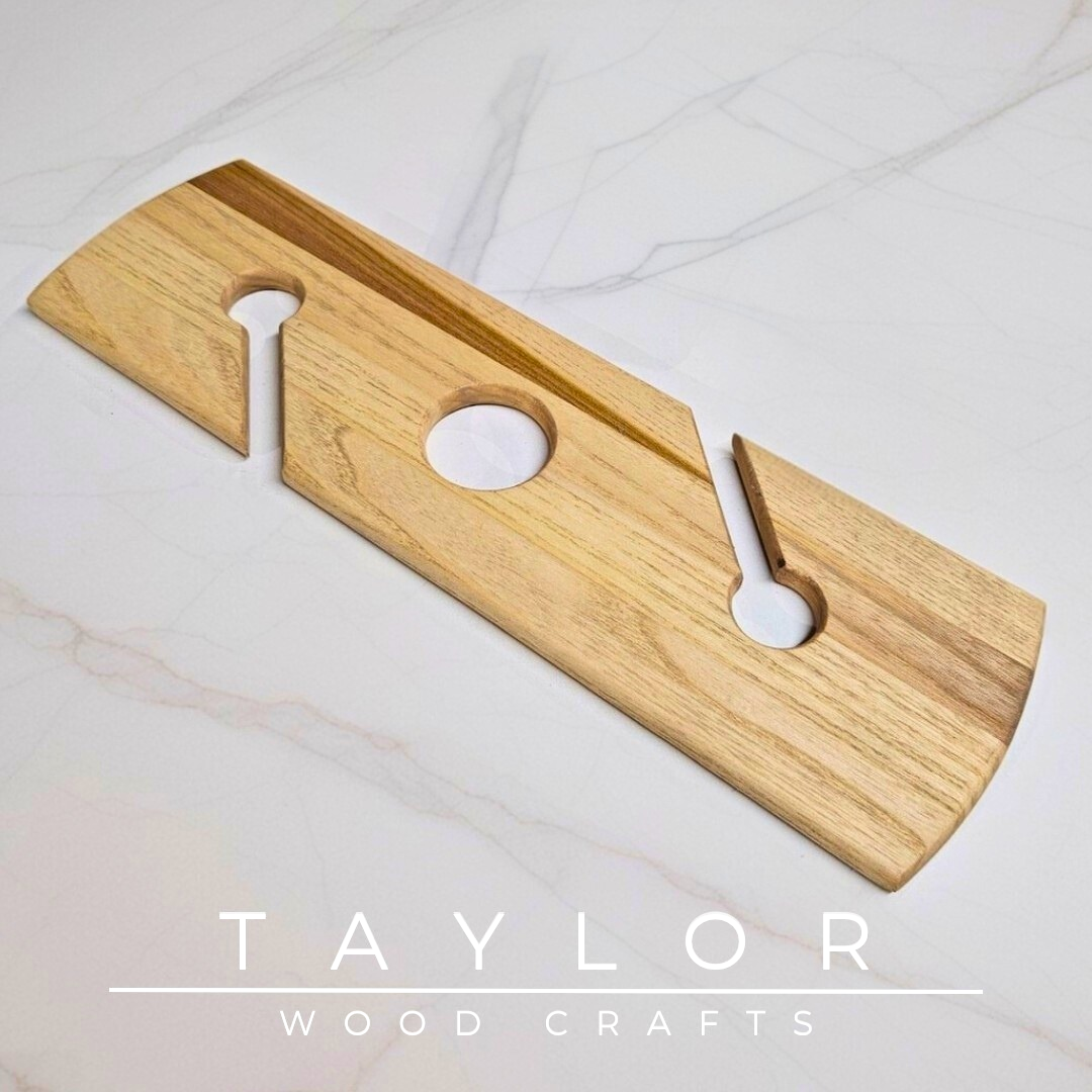 Wooden coasters and cutting boards with 'Taylor Wood Crafts' branding on a marble surface.