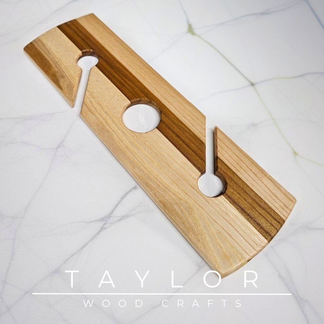 Wooden tool with three holes on a marble surface, branded 'Taylor Wood Crafts'.